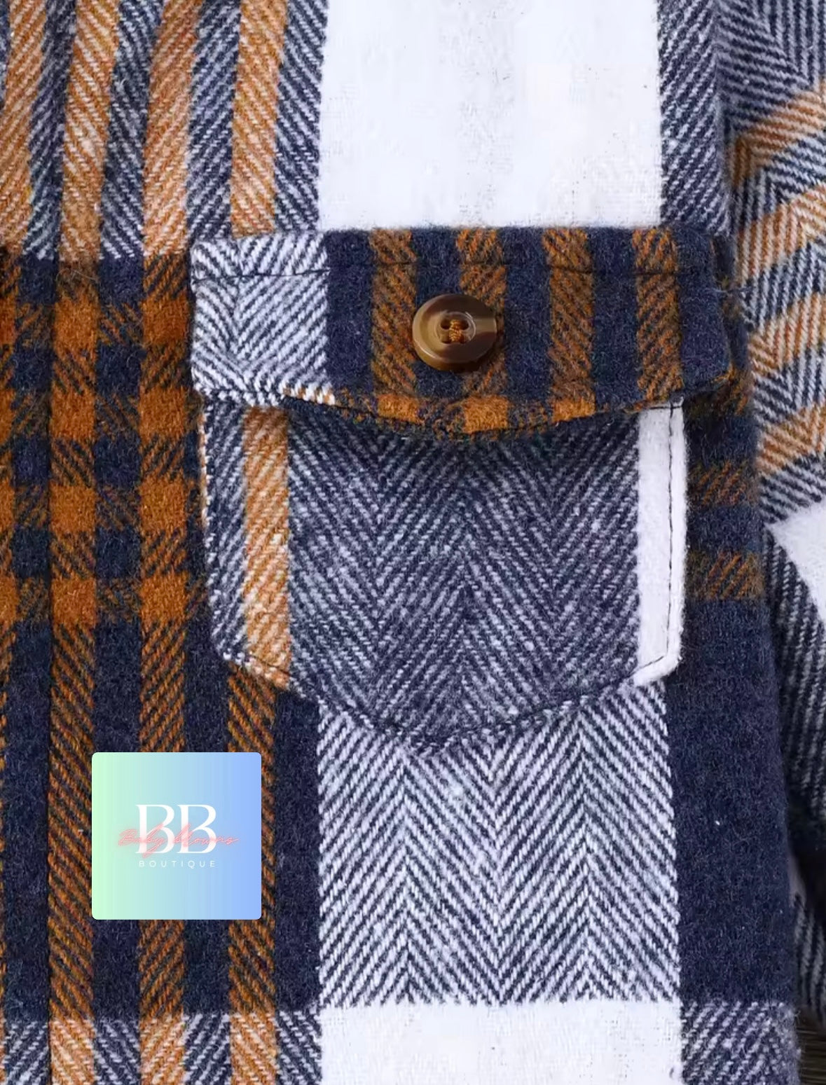 Close-up of a plaid shirt with a button and pocket, featuring a brand label.