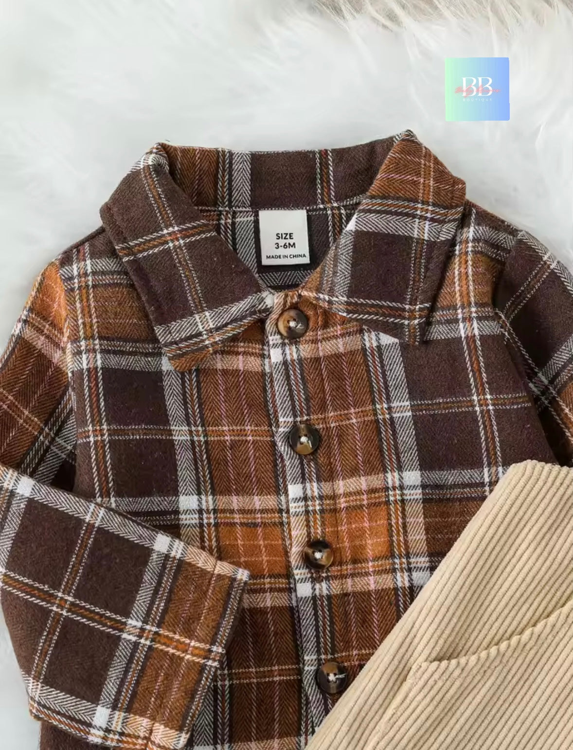 Brown plaid coat with a white label on a light background