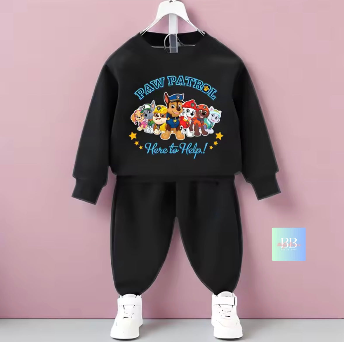 Black sweatshirt and pants set with Paw Patrol design on a pink background