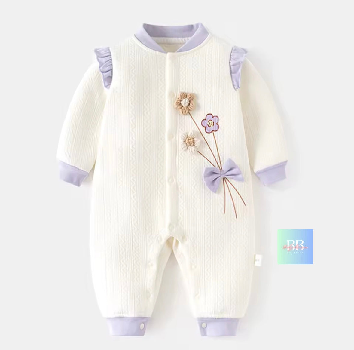 Baby onesie with floral design and purple accents on a white background