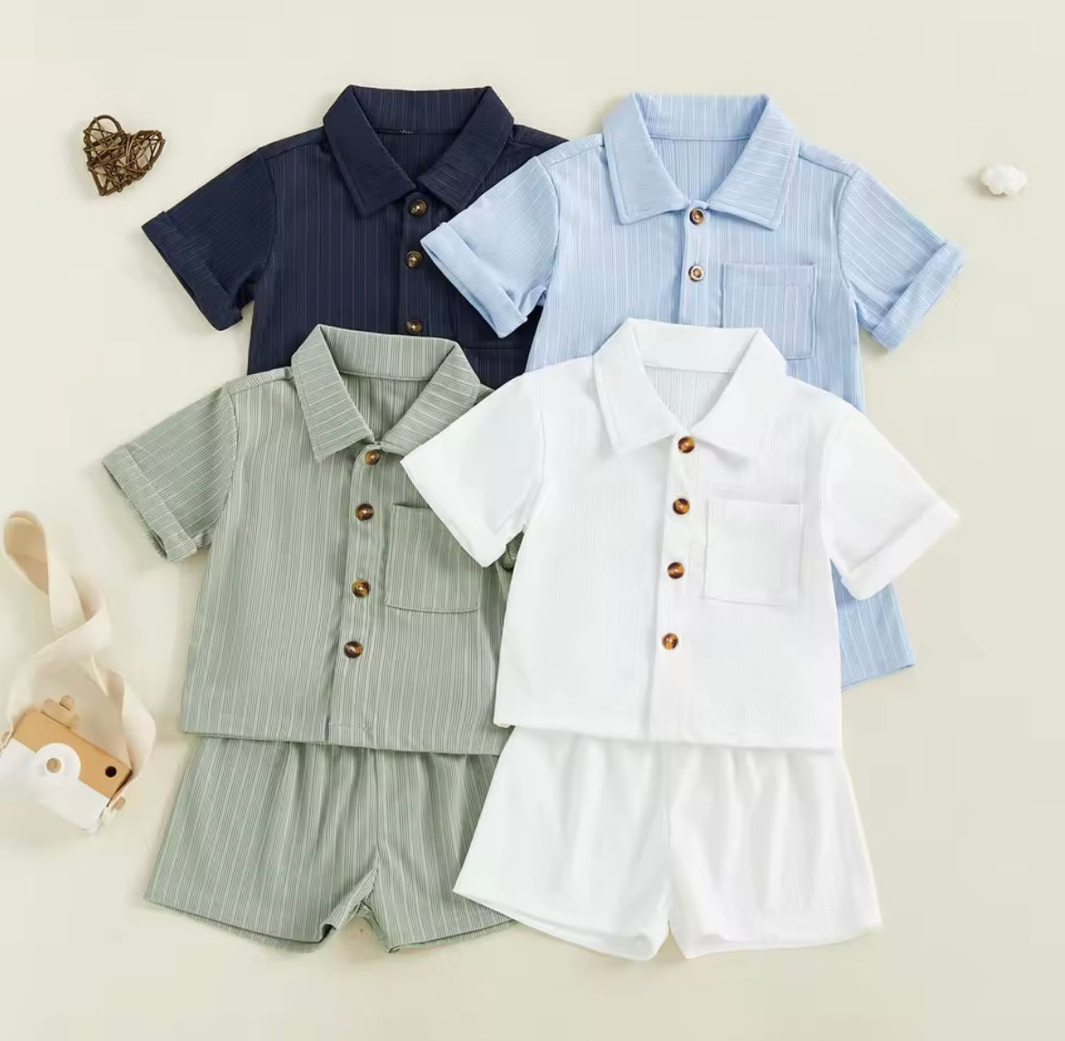 Set of children's shirts and shorts in various colors on a light background
