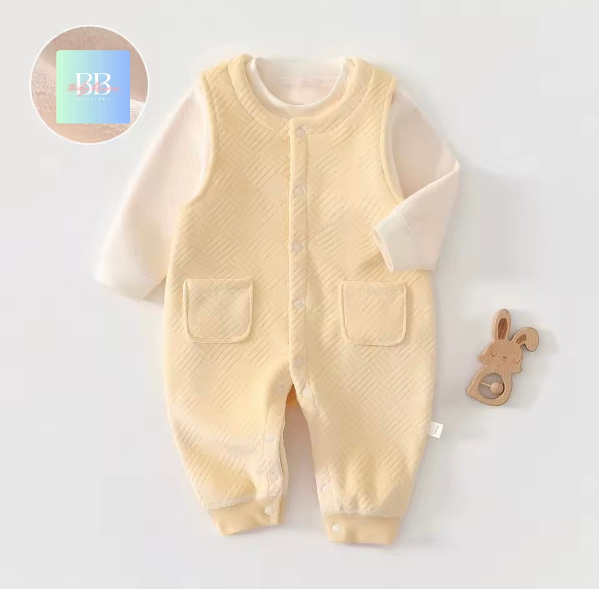 Baby romper with long-sleeve shirt on a light gray background