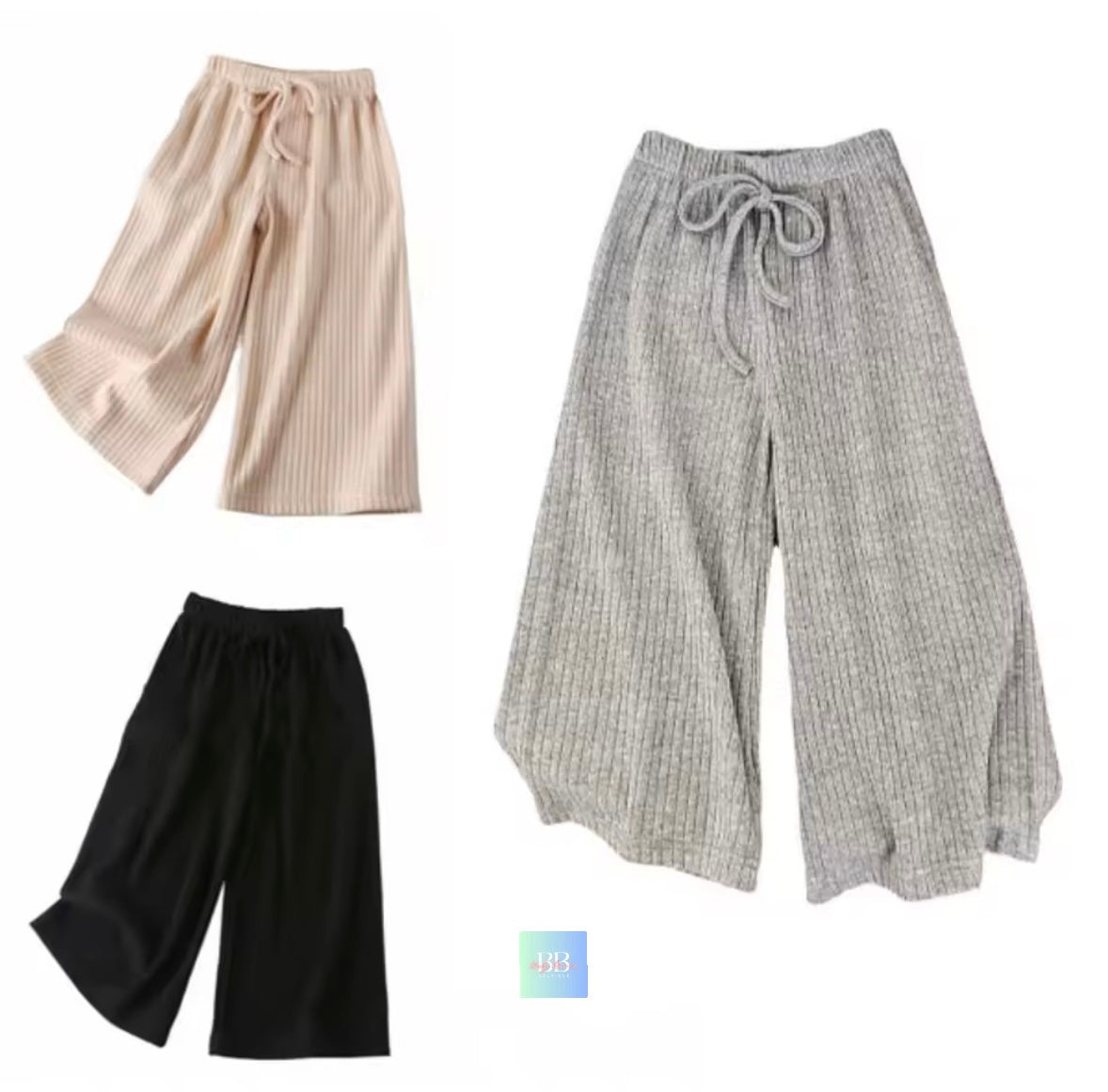 Three pairs of wide-leg pants in beige, gray, and black on a white background.