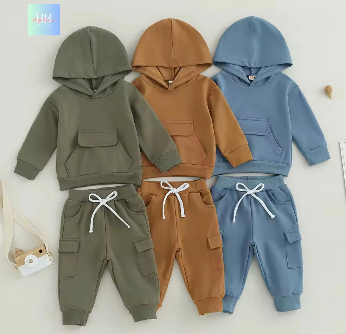 Three children's hoodies and pants set in green, brown, and blue on a white background.