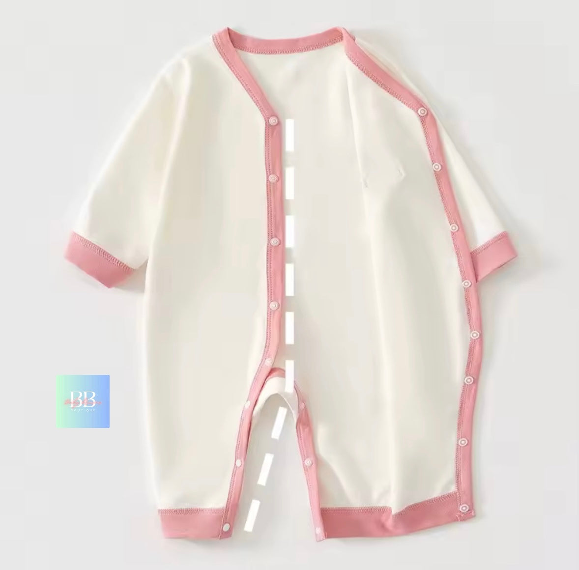 White baby romper with pink trim on a white background