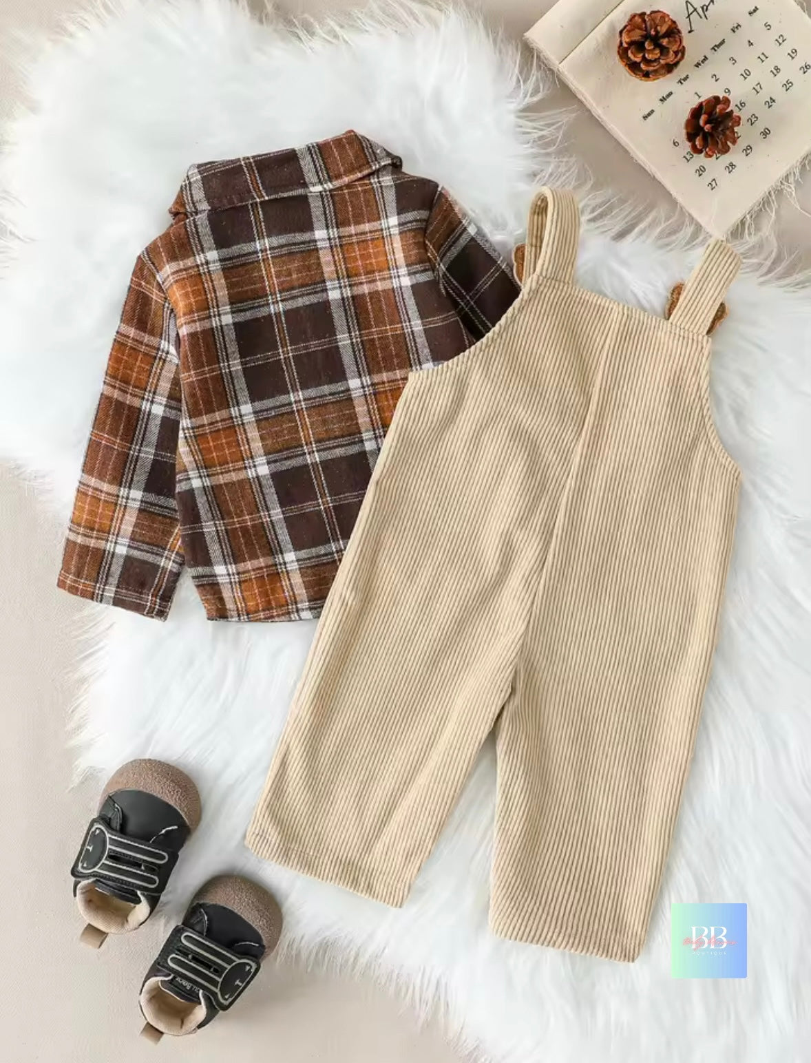 Plaid shirt, beige overalls, and shoes on a white fur surface