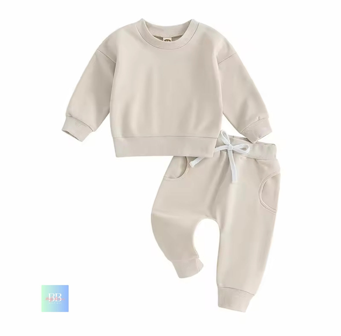 Beige baby sweatshirt and pants set on a white background