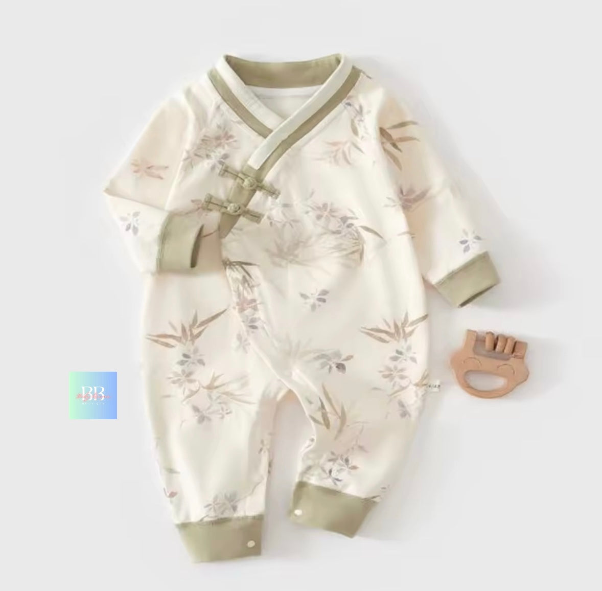 Baby romper with floral pattern and matching hat on a white background