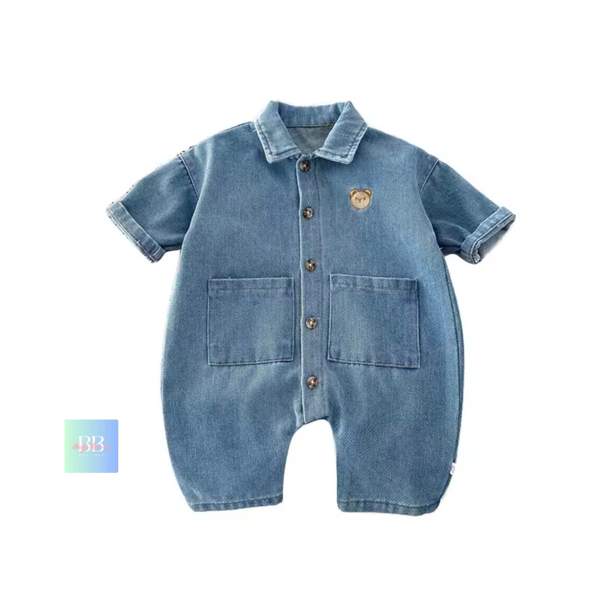 Blue denim baby romper with bear emblem on a white background