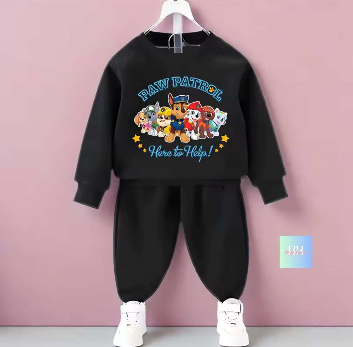 Black children's outfit with Paw Patrol design on a pink background