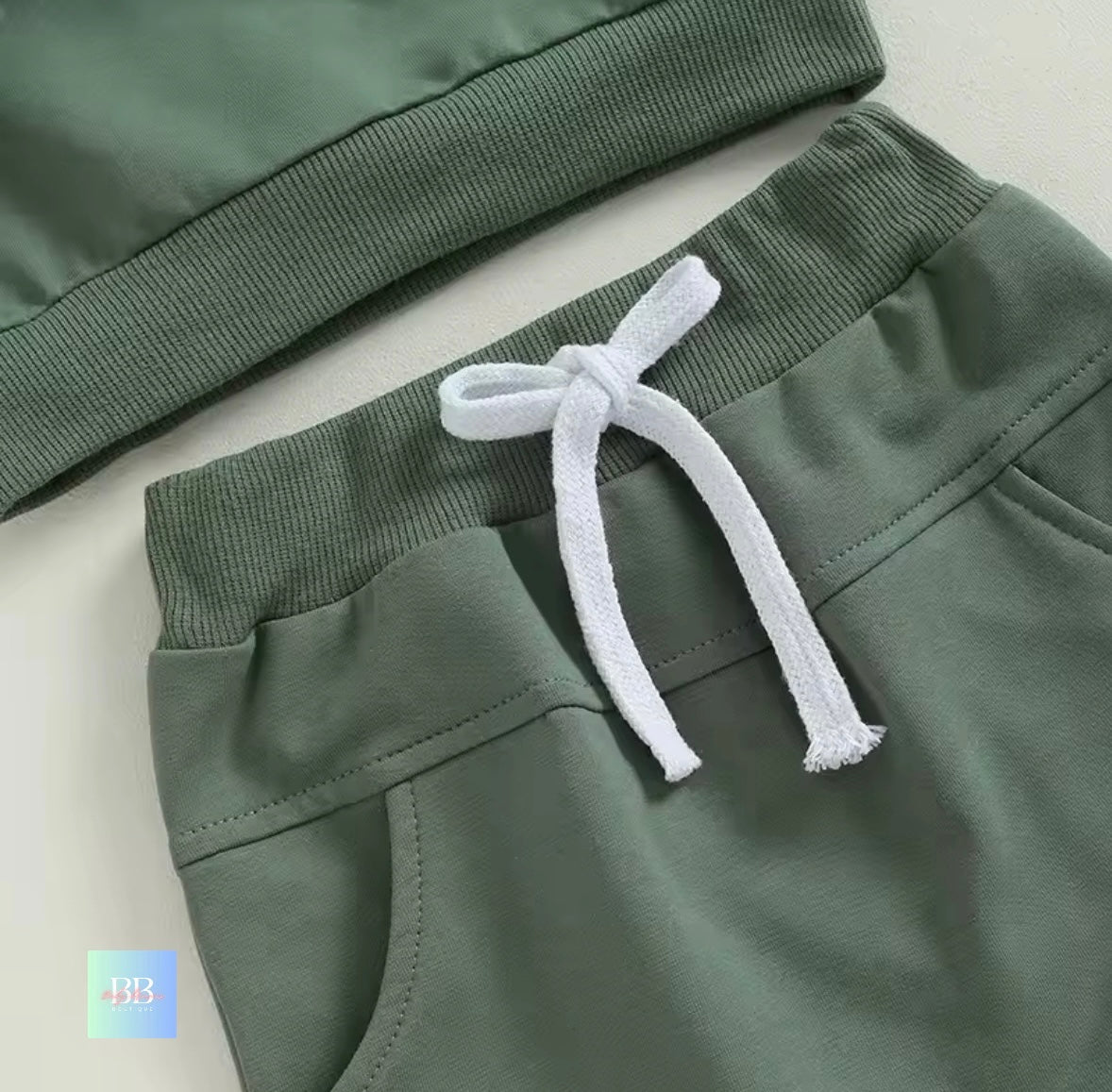 Green pants with a drawstring on a light background