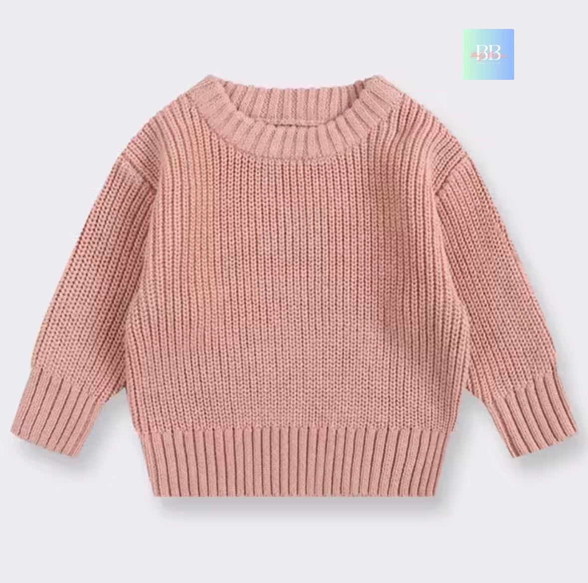 Pink knitted sweater on a light gray background