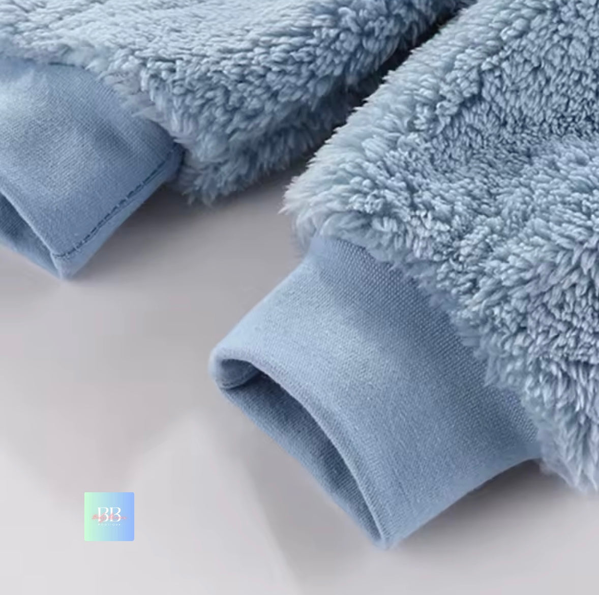 Close-up of fluffy blue towels on a light gray surface