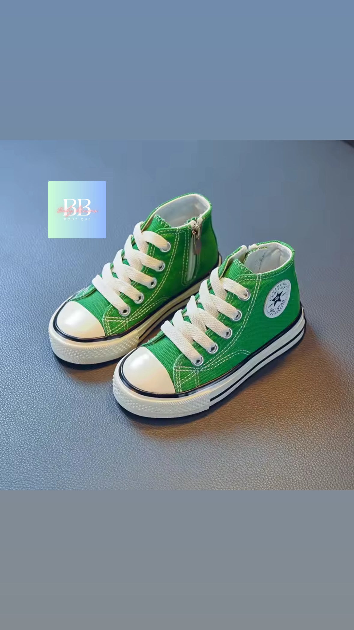 Green high-top sneakers with white laces on a blue surface