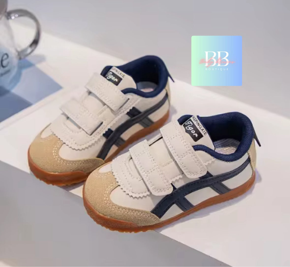 Pair of children's shoes with a visible brand logo on a light background