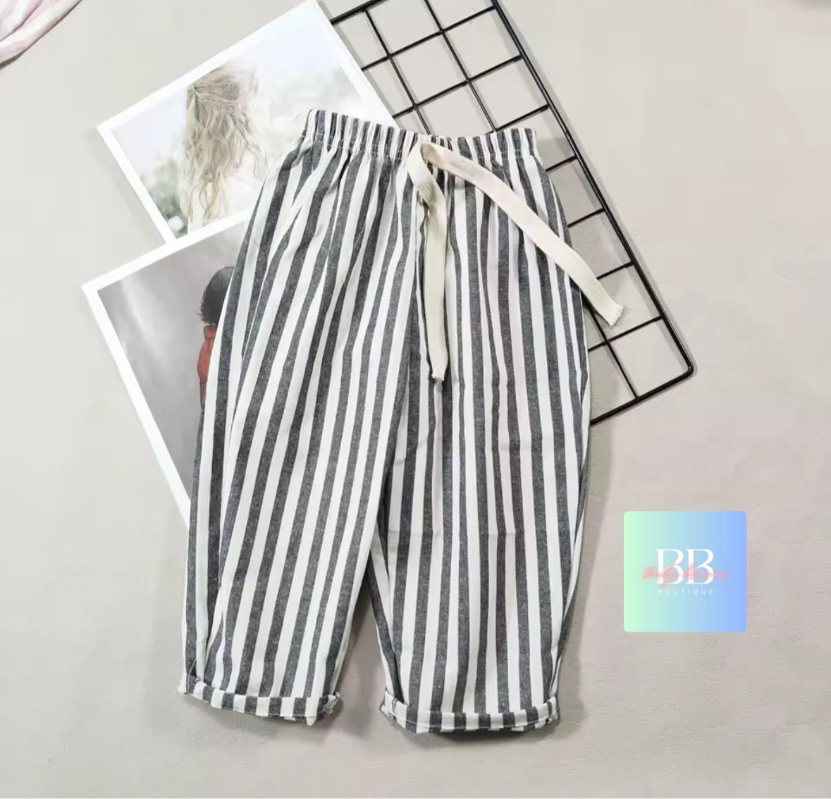 Striped pants with a drawstring on a light gray surface