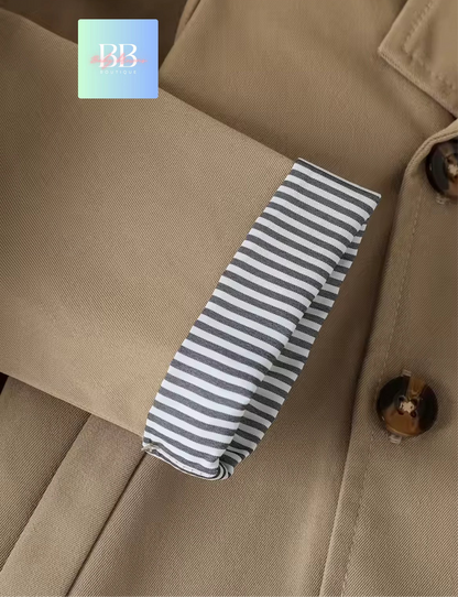 Striped tie on a beige coat with a brand logo in the corner