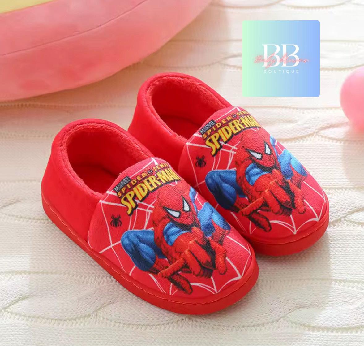 Red Spider-Man slippers on a light background with a visible brand logo.