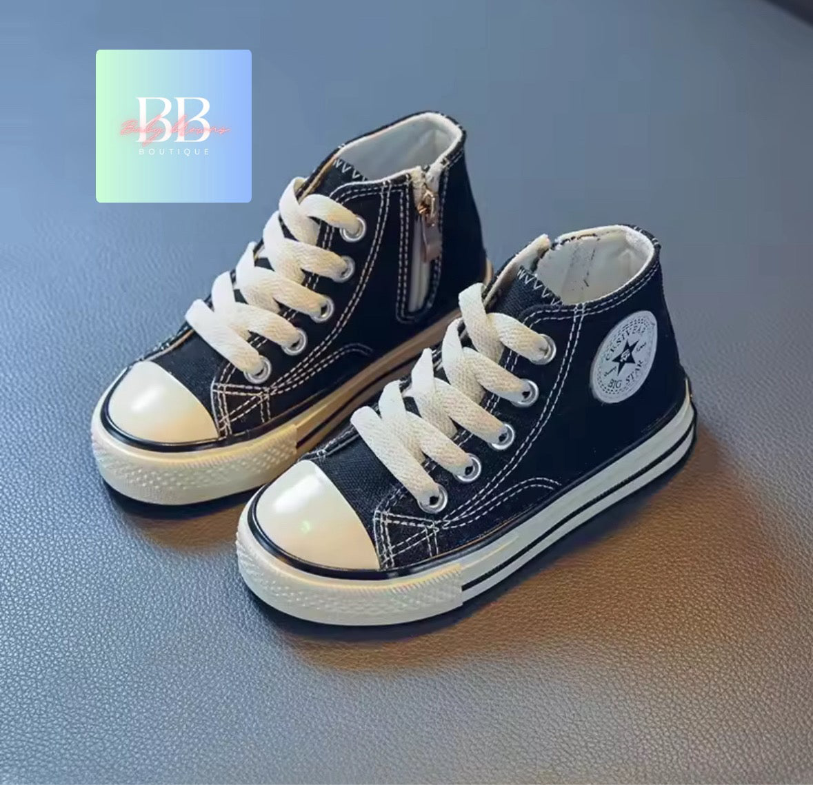 Pair of navy high-top sneakers with white laces on a blue background, featuring a brand logo in the corner.