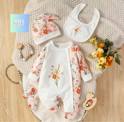 Baby outfit set with floral patterns on a textured surface with flowers and toys.