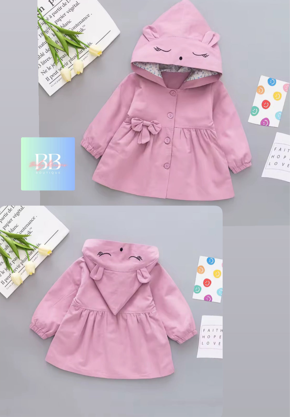 Pink children's coat with hood on a gray background