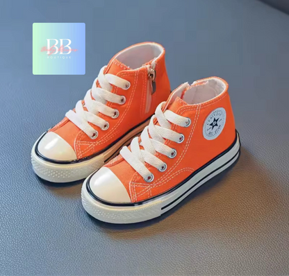 Orange high-top sneakers with white laces on a gray surface, featuring a brand logo in the corner.