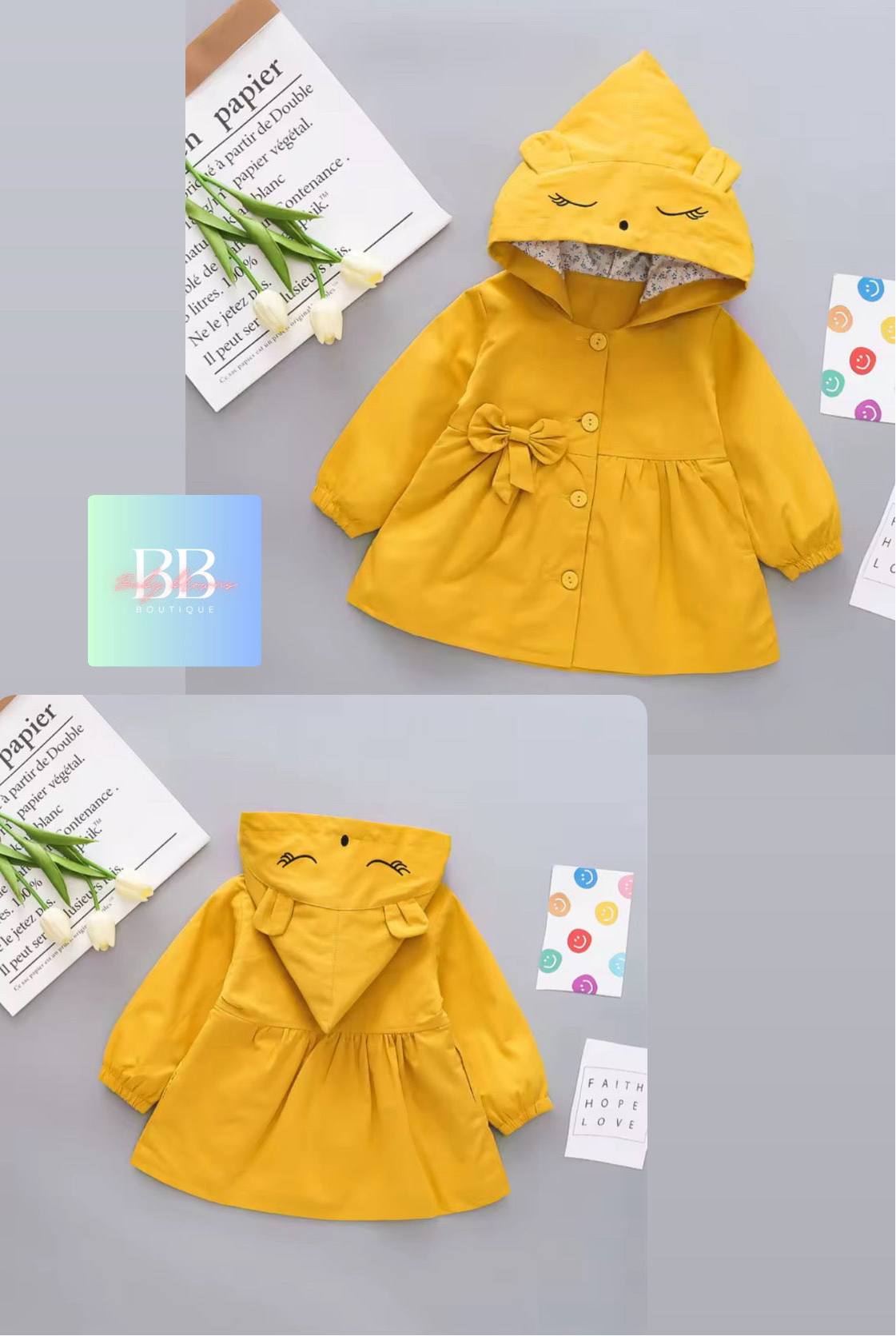 Yellow children's coat with a hood on a gray background