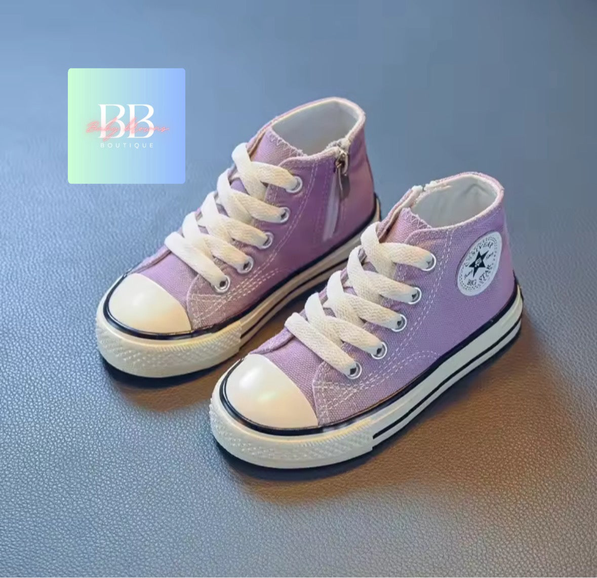 Pair of purple high-top sneakers with white laces on a blue background