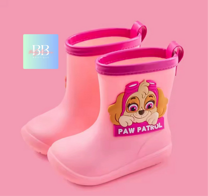 Pink rain boots with a Paw Patrol character on a pink background