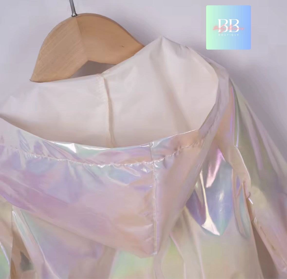 Iridescent fabric on a wooden hanger with a blurred background