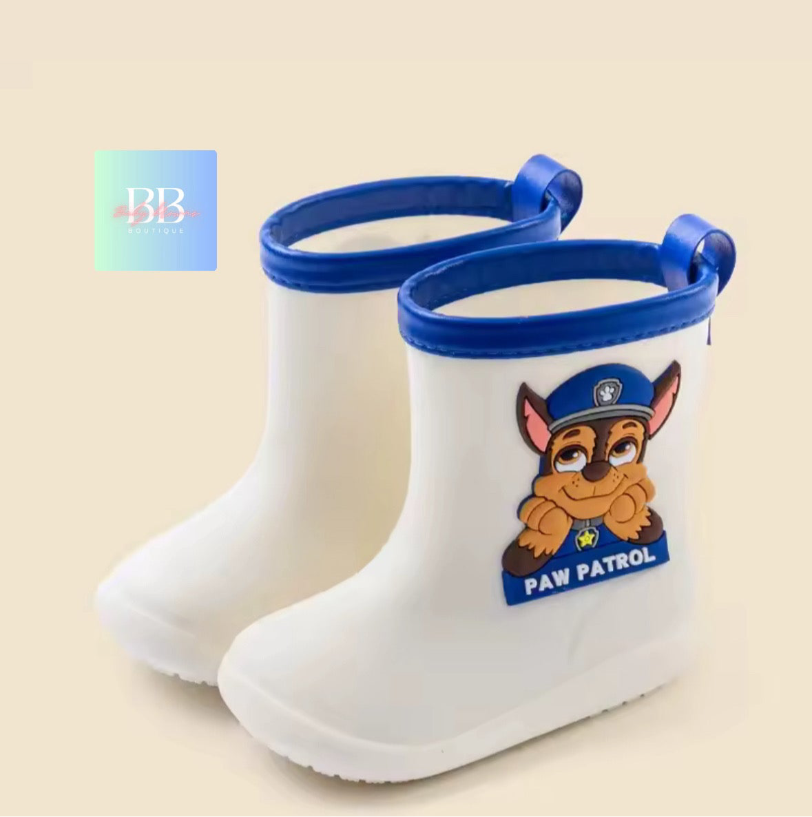 White rain boots with blue trim featuring a Paw Patrol character on a beige background