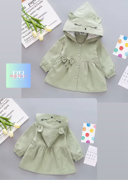 Two green children's hoodies with animal ears on a gray surface.