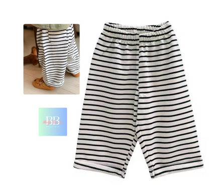 Black and white striped pants on a white background with a small logo in the corner.