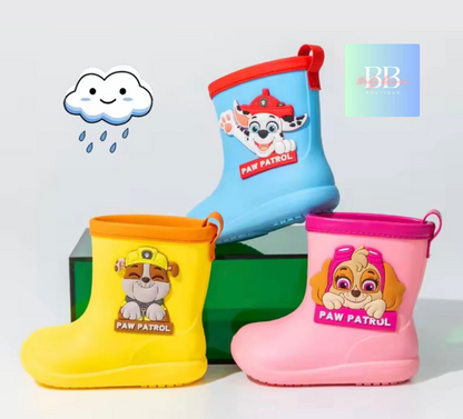 Three children's rain boots with Paw Patrol characters on a light gray background.