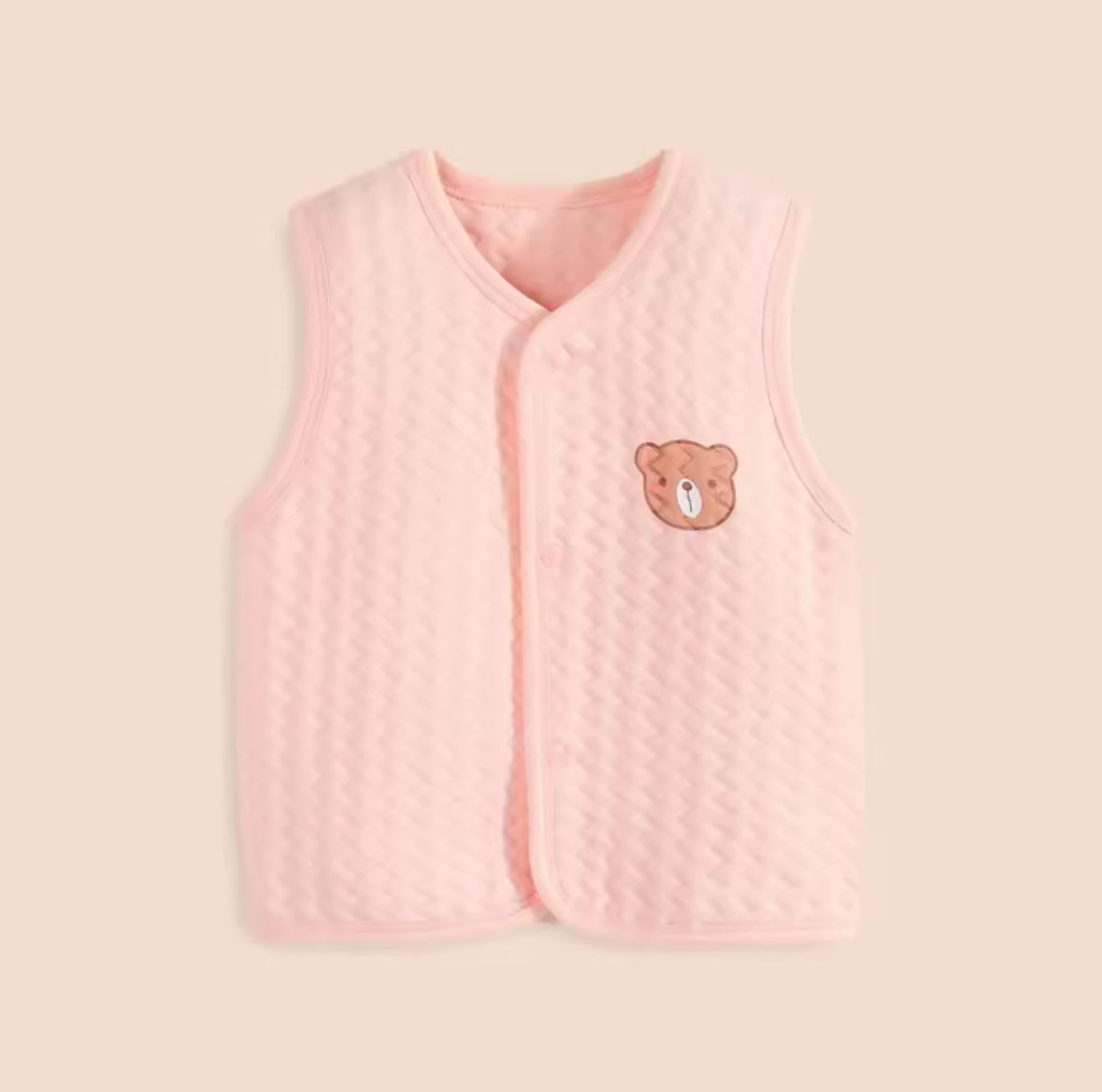 Pink quilted vest with a bear emblem on a beige background soft cotton waistcoat/bodwarmer
