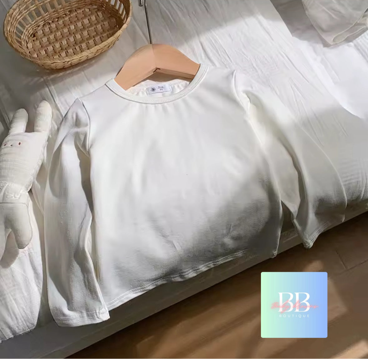 White shirt on a hanger with gloves and a basket in the background