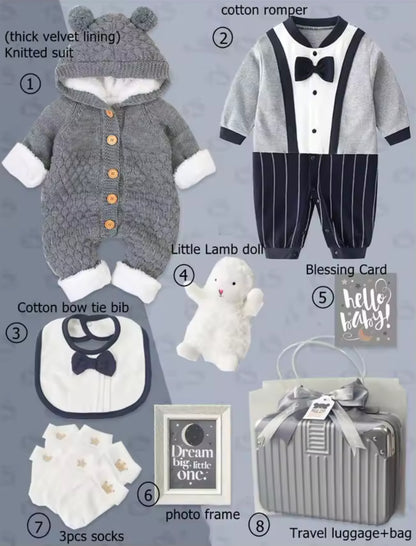 Collection of baby items including a knitted suit, romper, bib, plush toy, photo frame, and travel bag on a gray background.