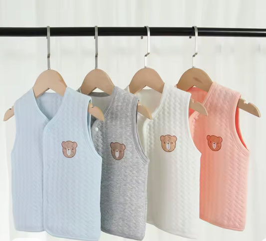 Five children's tank tops with bear designs on hangers against a white background