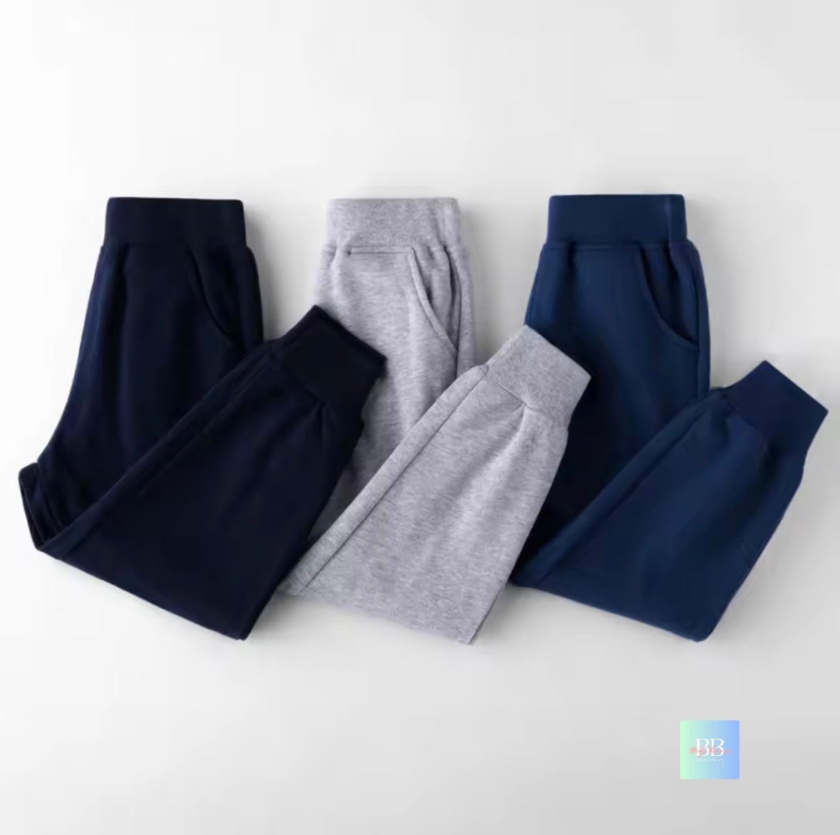 Two pairs of pants, one navy and one gray, on a white background.