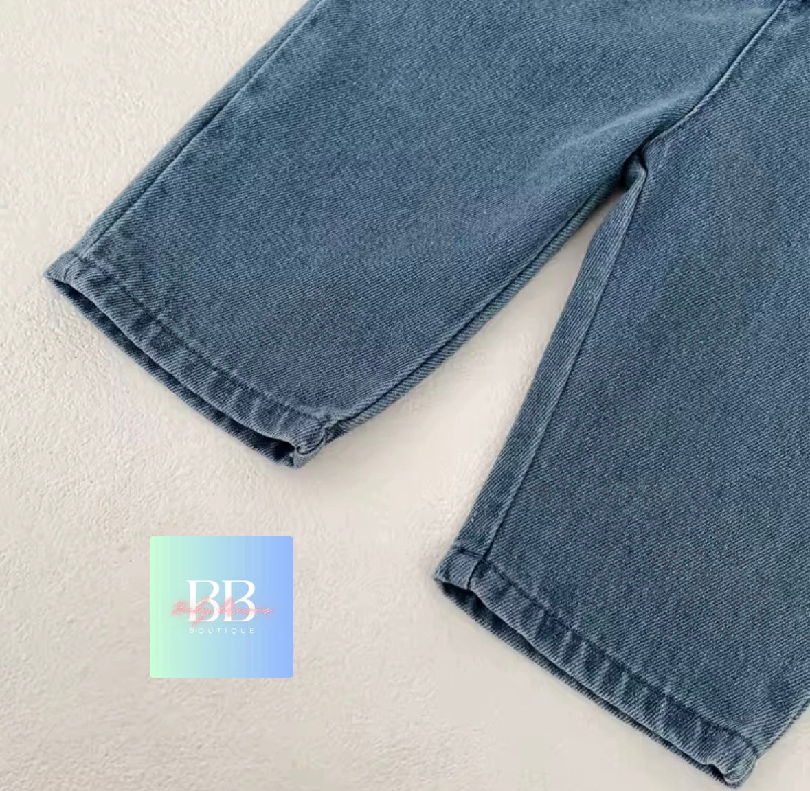 Blue jeans with a brand logo on a light background