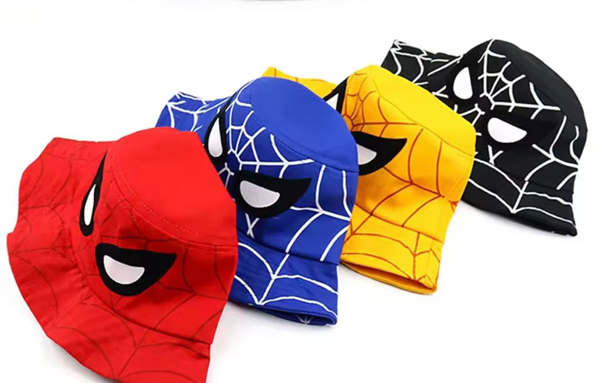 Four superhero-themed beanies in red, blue, yellow, and black on a white background