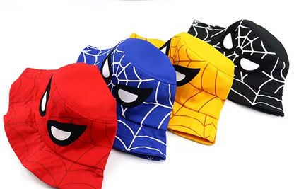 Four superhero-themed beanies in red, blue, yellow, and black on a white background