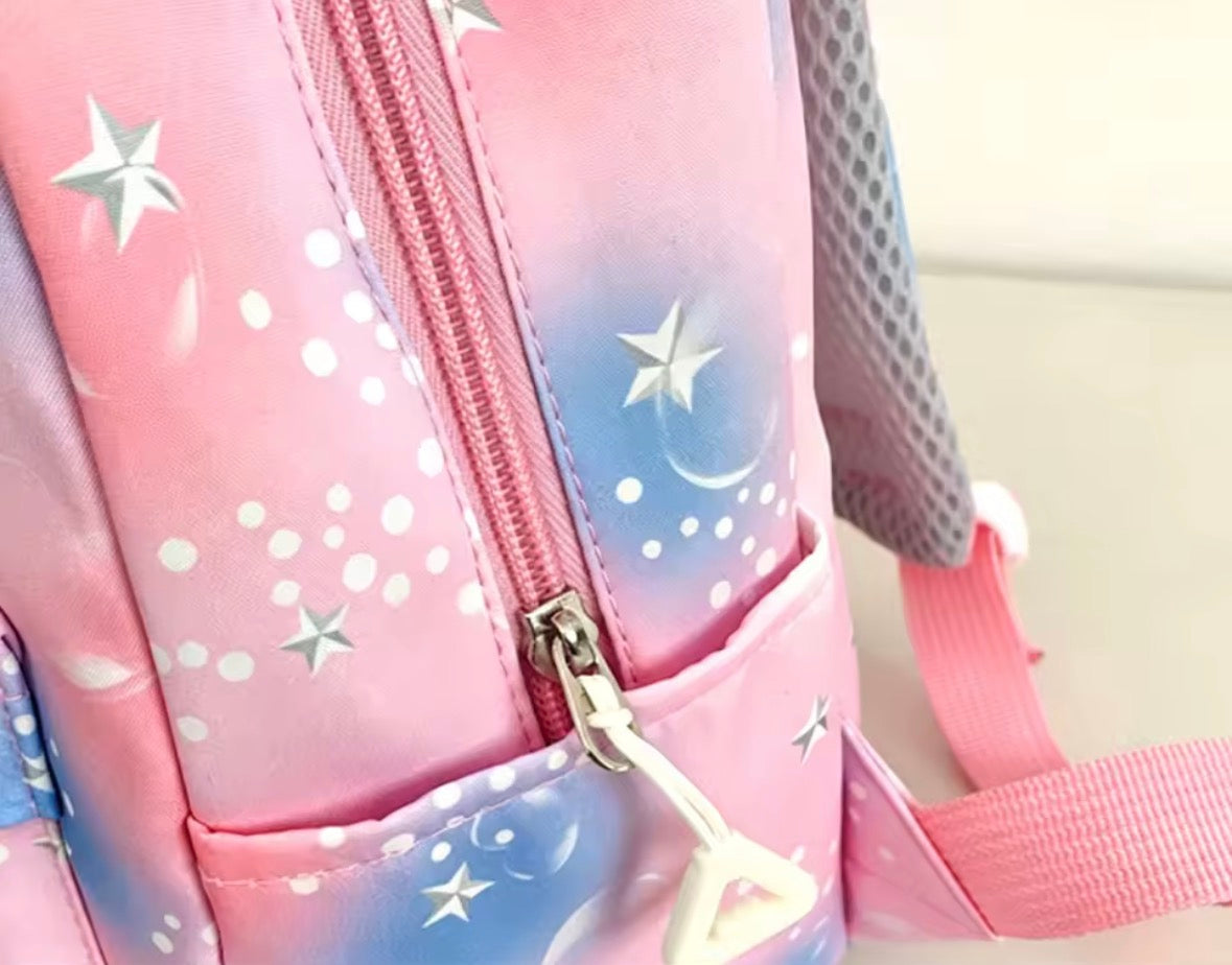 Pink backpack with star and moon designs on a light background