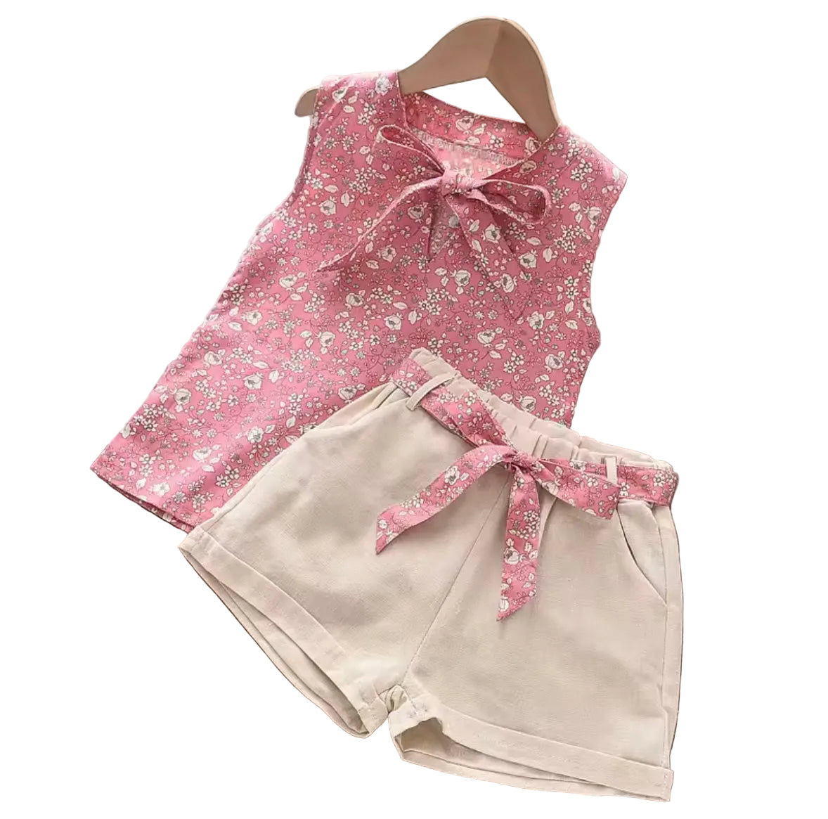 Pink floral top and beige shorts set on a white background