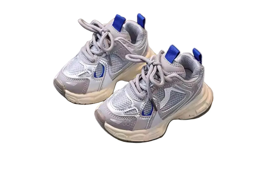 Pair of gray sneakers with blue accents on a light surface