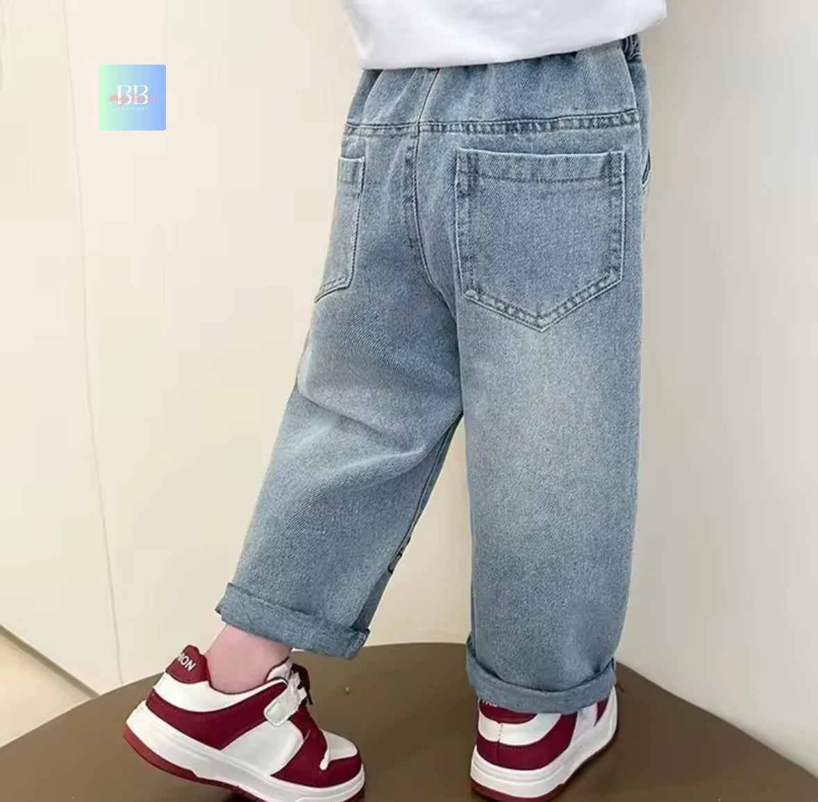 Light blue jeans worn by a person on a neutral background