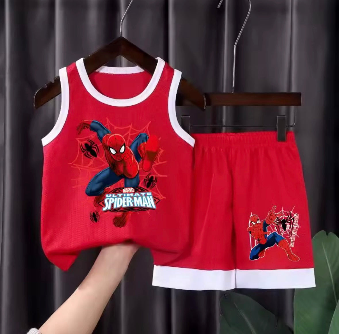 Red Spider-Man tank top and shorts set on a hanger against a dark background