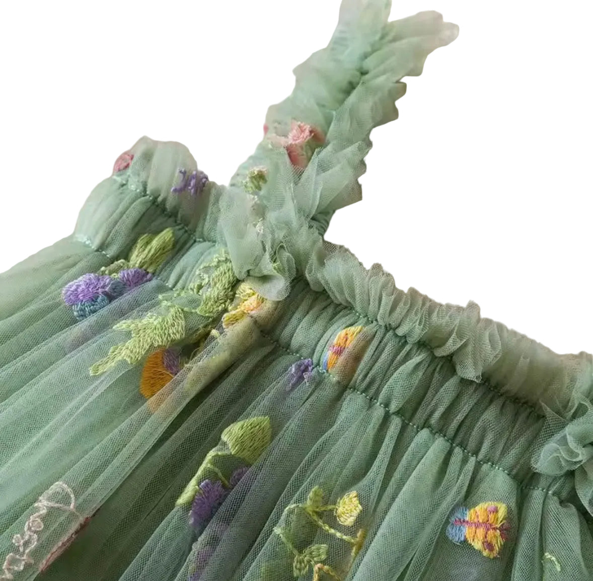 Green embroidered dress with floral details on a textured beige background