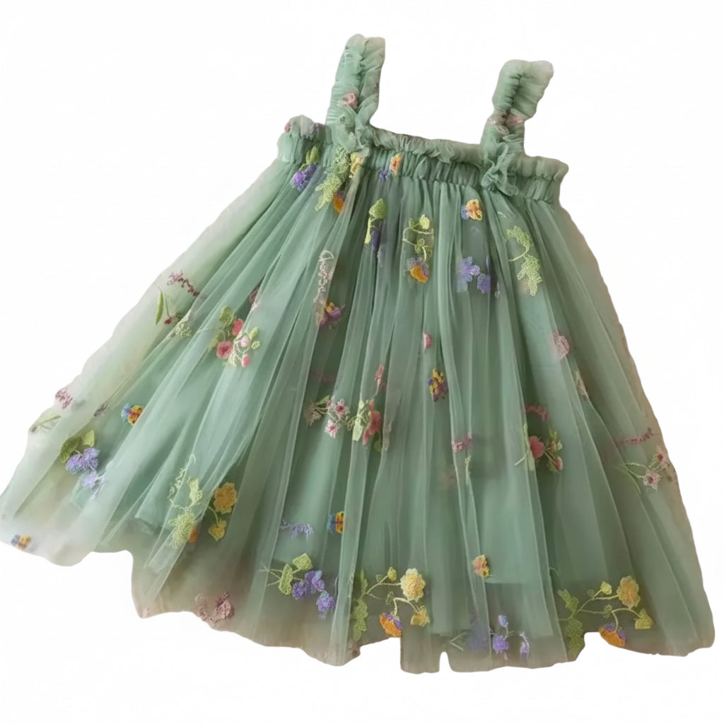 Green floral dress on a textured surface with flowers and butterflies around