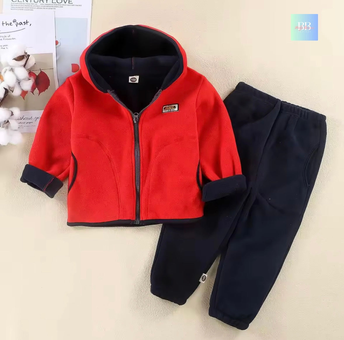 Red jacket and black pants set on a light background